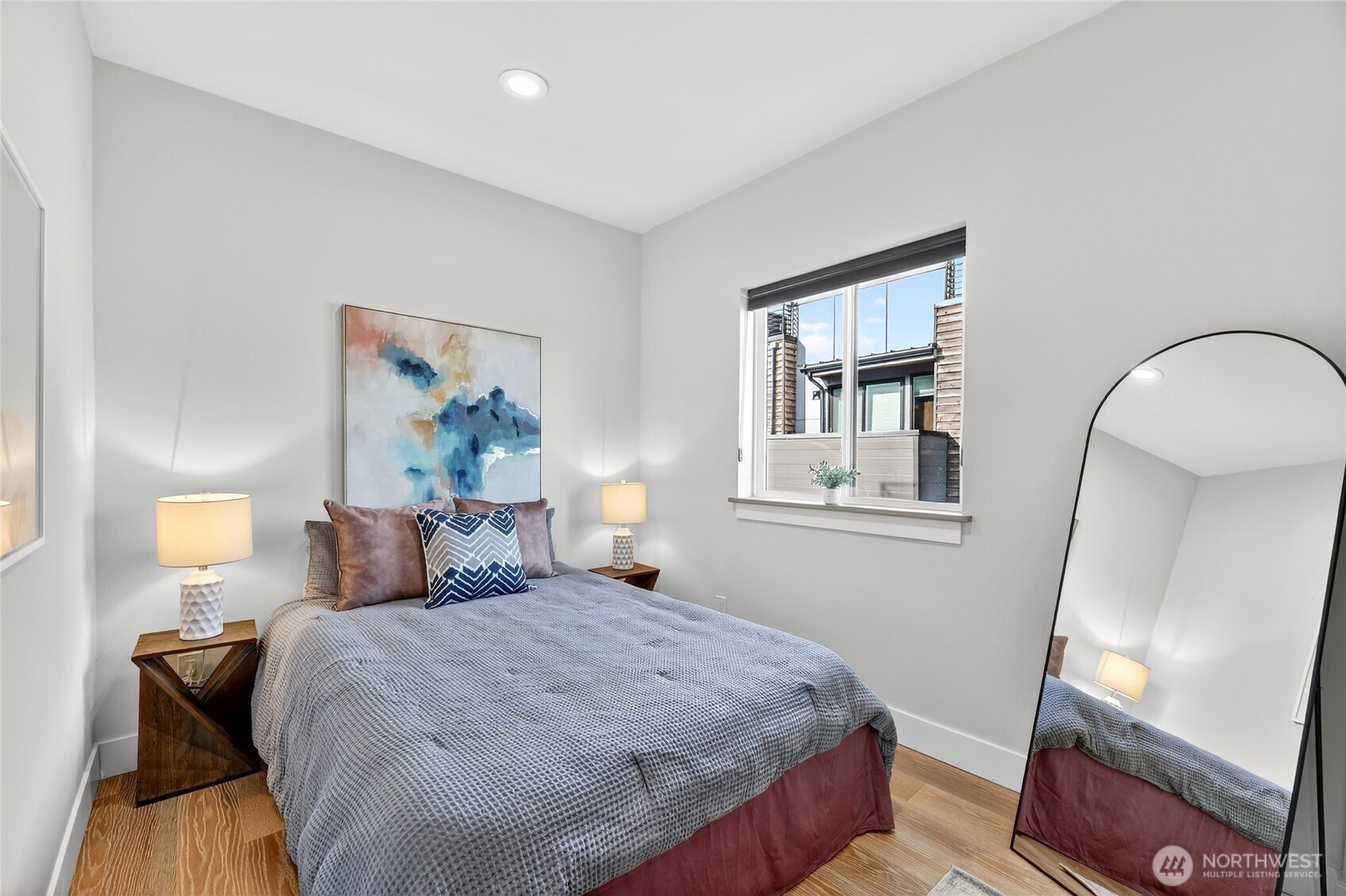 6543 35th Avenue Southwest, Unit B Seattle, WA 98126 - Photo 27 of 37 a bedroom with a bed and a mirror