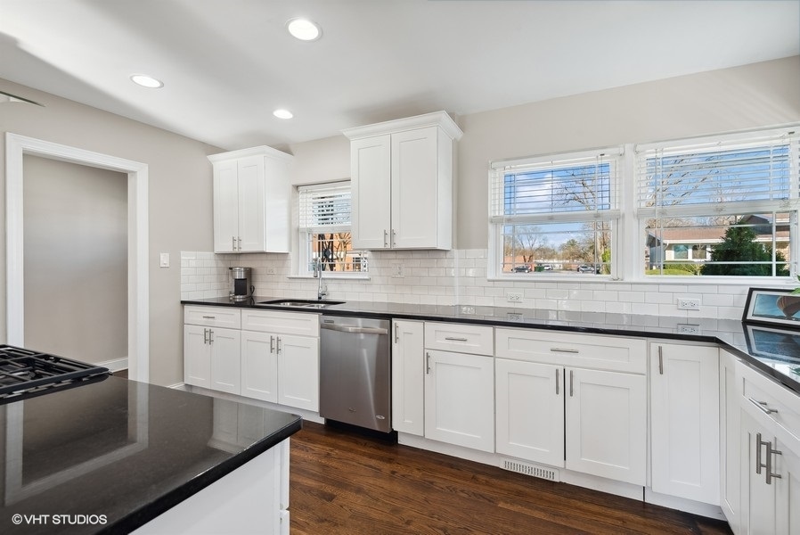 537 Romona Road Wilmette, IL 60091 - Photo 6 of 35 a kitchen with stainless steel appliances granite countertop a sink stove and refrigerator