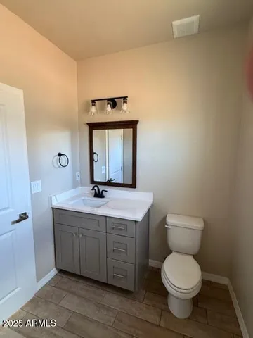 a bathroom with a toilet a sink and mirror