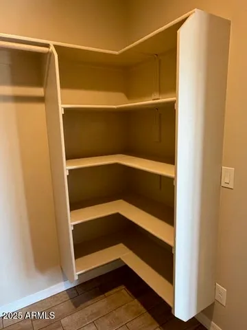 a view of walk in closet with empty racks