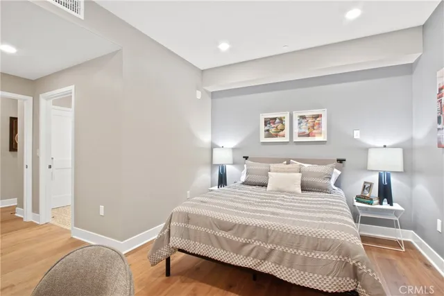 a bedroom with a bed and a night stand