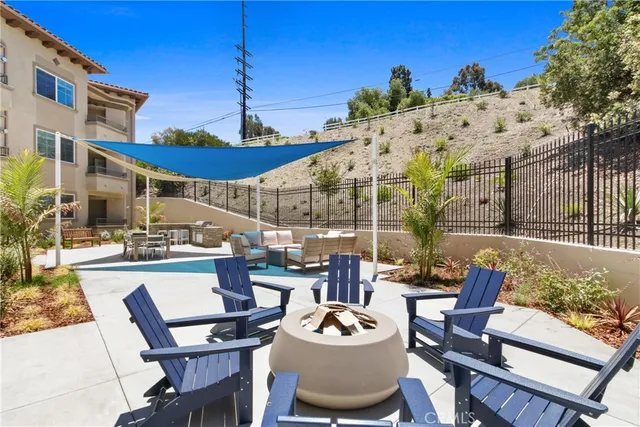a view of a patio with couches table and chairs and potted plants