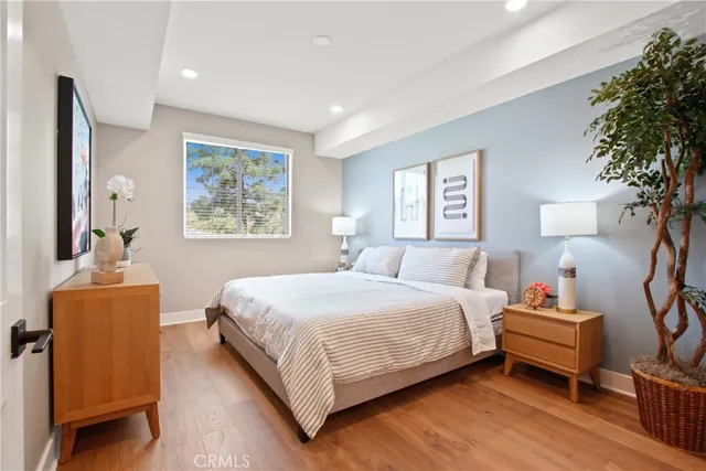 a bedroom with bed and a potted plant