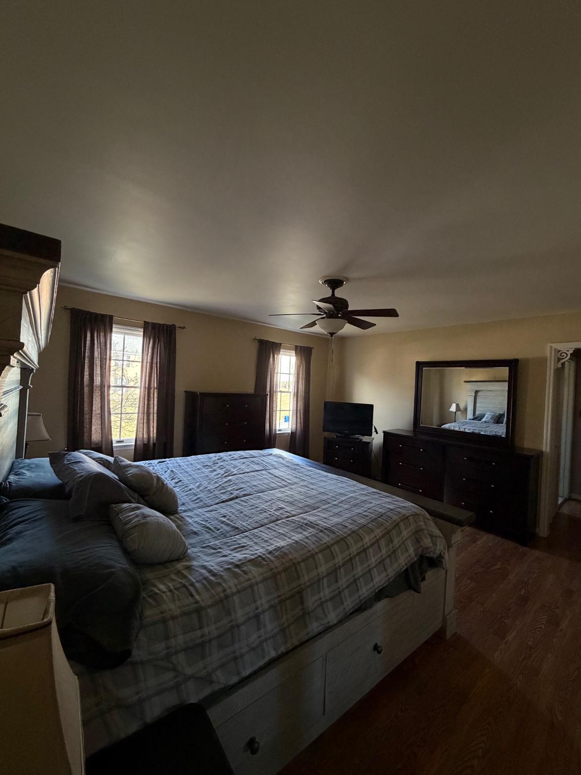119 Constitution Avenue Reading, PA 19606 - Photo 14 of 15 a bedroom with a bed a mirror and a chandelier