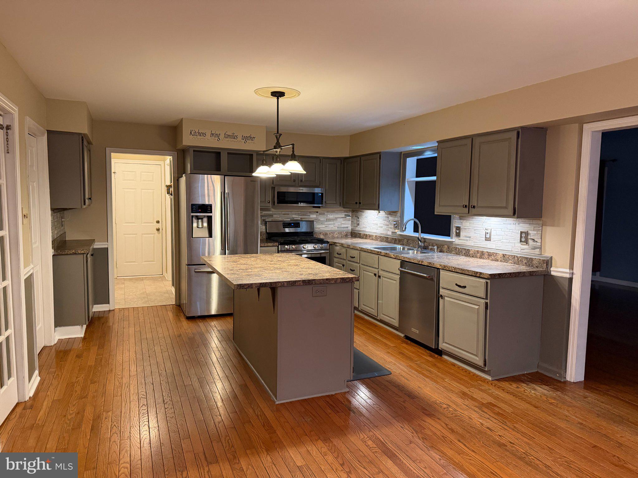 119 Constitution Avenue Reading, PA 19606 - Photo 2 of 15 a kitchen with kitchen island a counter top space a sink appliances and cabinets