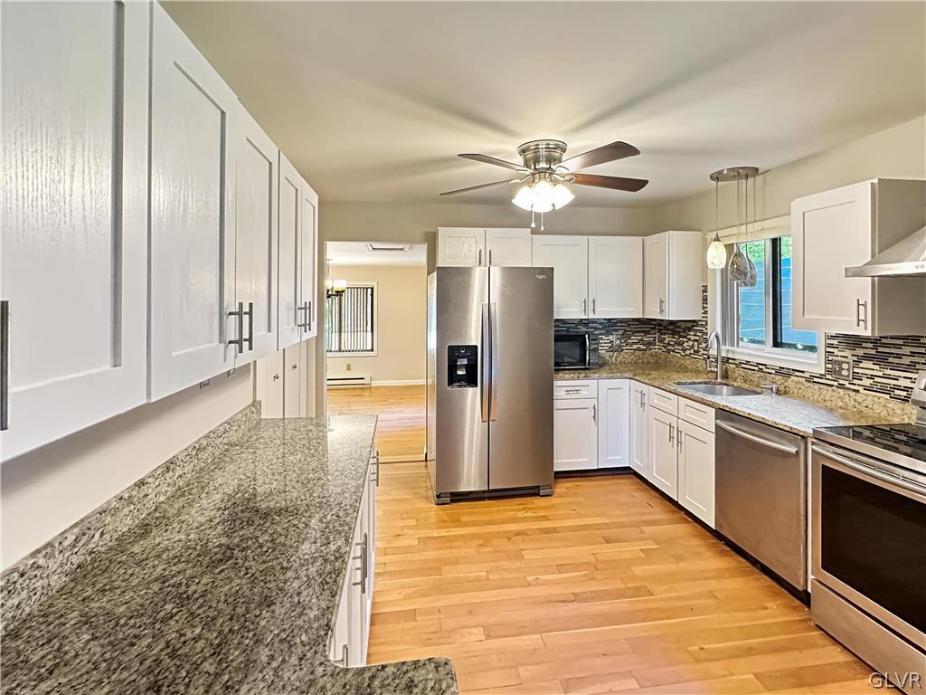 1432 Clover Road Long Pond, PA 18334 - Photo 4 of 16 a large kitchen with cabinets and stainless steel appliances
