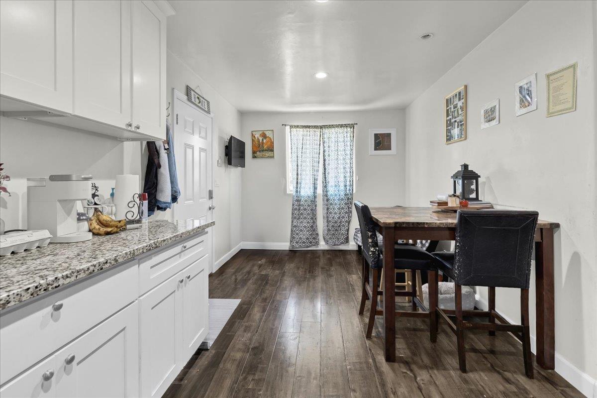 18810 Moro Road Salinas, CA 93907 - Photo 28 of 40 a kitchen with granite countertop dining room cabinets and wooden floor