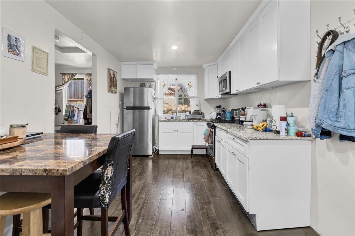 18810 Moro Road Salinas, CA 93907 - Photo 29 of 40 a kitchen with stainless steel appliances granite countertop a refrigerator a sink dishwasher a stove and white countertops with wooden floor