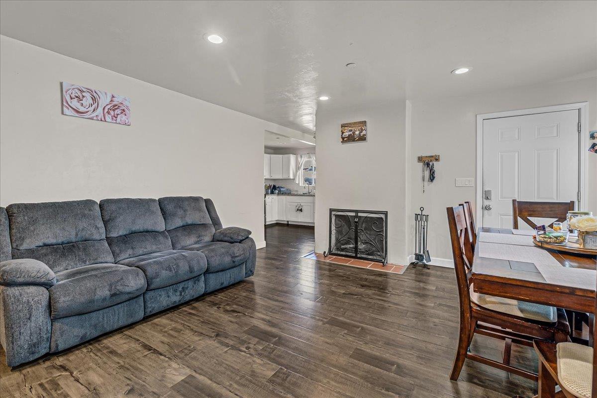 18810 Moro Road Salinas, CA 93907 - Photo 6 of 40 a living room with furniture a fireplace and wooden floor