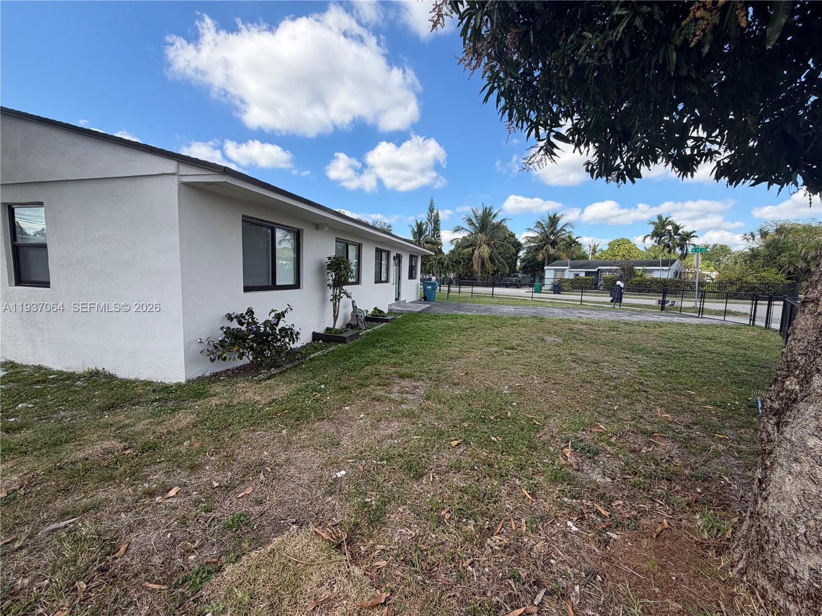 7330 Southwest 11th Street, Unit 7330 Miami, FL 33144 - Photo 15 of 25 a backyard of a house with table and chairs