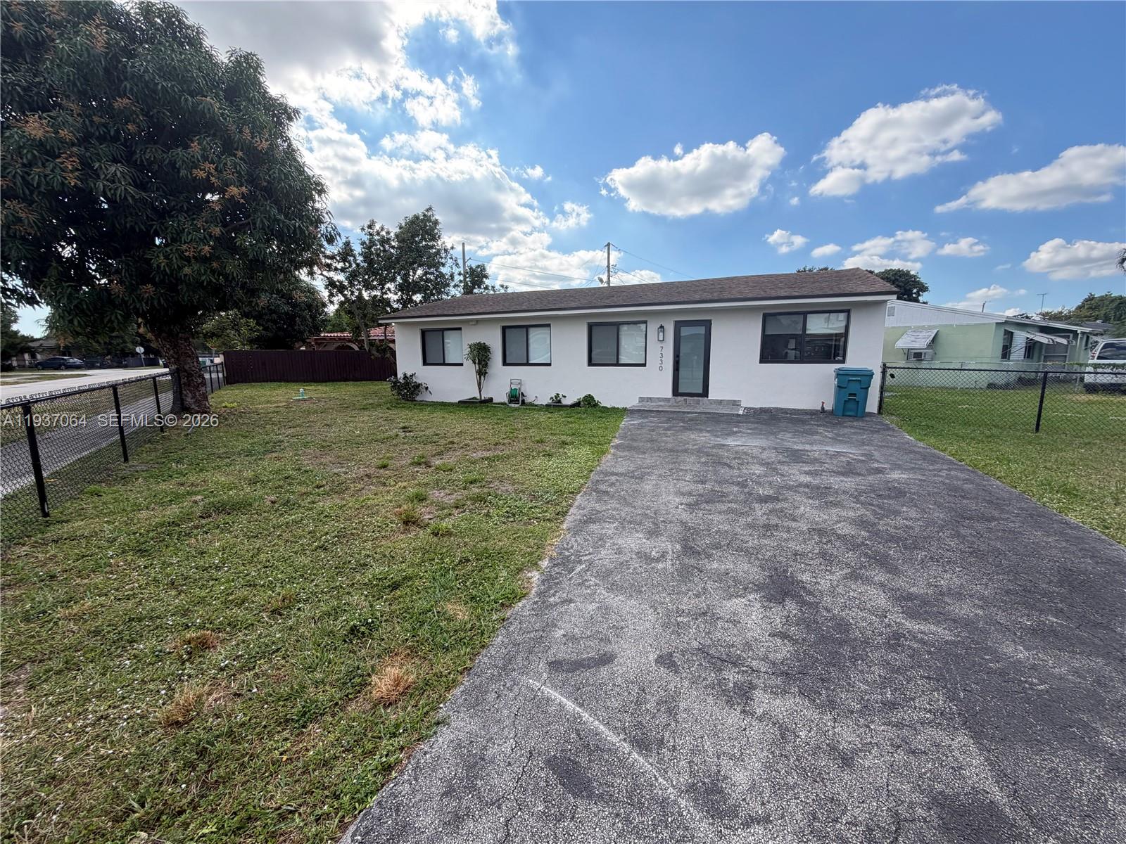 7330 Southwest 11th Street, Unit 7330 Miami, FL 33144 - Photo 3 of 25 a view of a house with yard and a garden