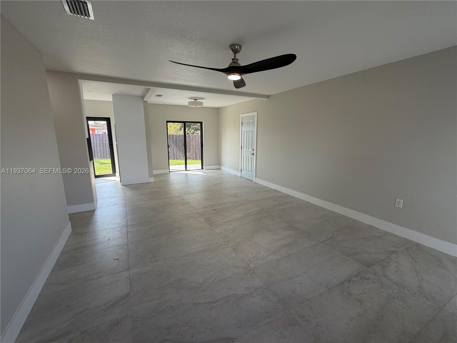 7330 Southwest 11th Street, Unit 7330 Miami, FL 33144 - Photo 5 of 25 a view of a livingroom with wooden floor and a ceiling fan
