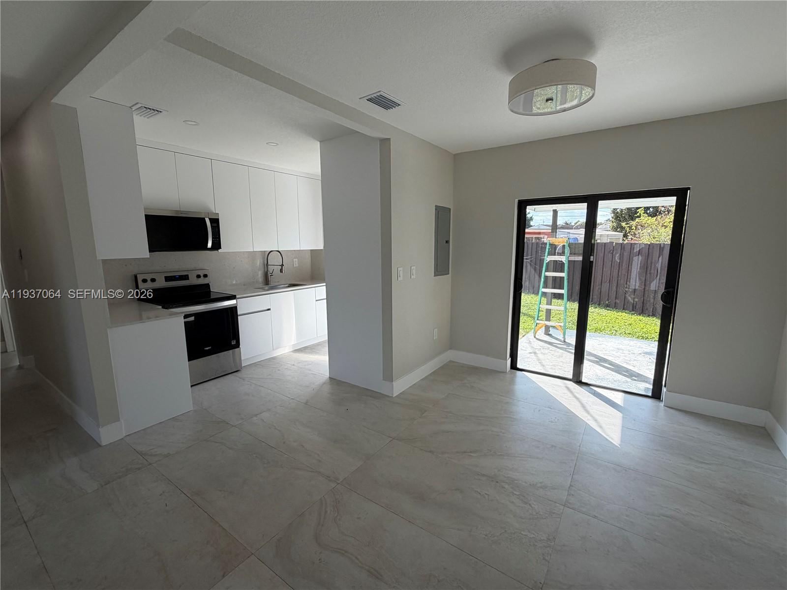 7330 Southwest 11th Street, Unit 7330 Miami, FL 33144 - Photo 6 of 25 a view of a kitchen with a sink and a window