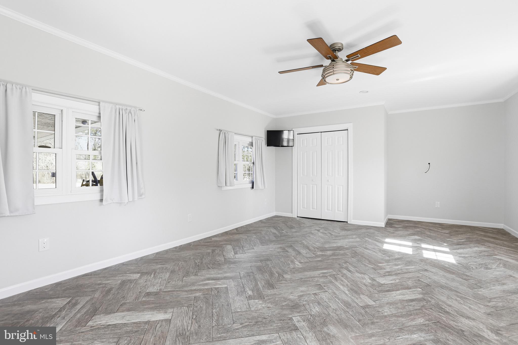 8324 Newland Road Warsaw, VA 22572 - Photo 11 of 31 a view of a livingroom with a ceiling fan & hardwood floor