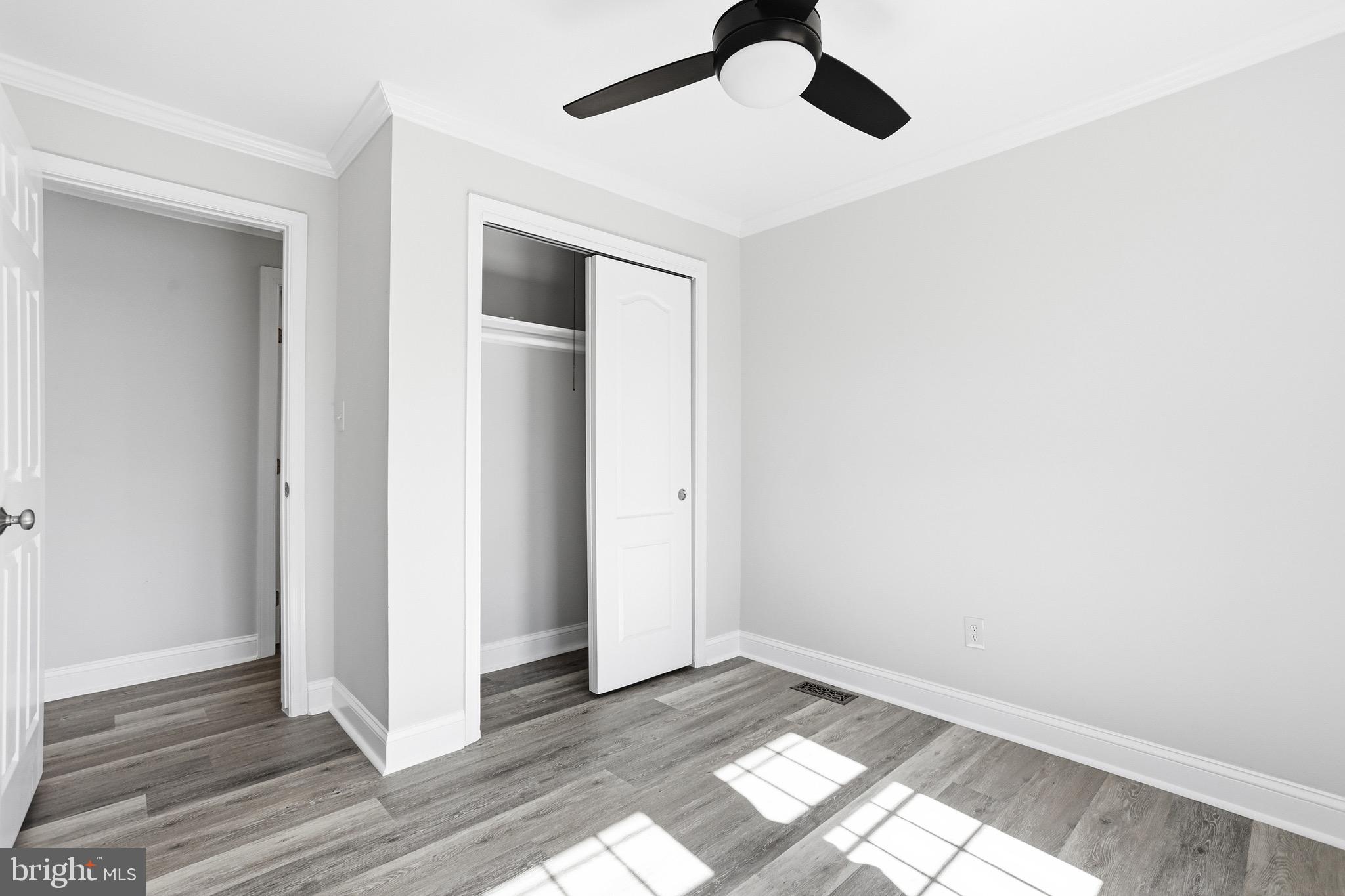 8324 Newland Road Warsaw, VA 22572 - Photo 16 of 31 an empty room with wooden floor cabinet and windows