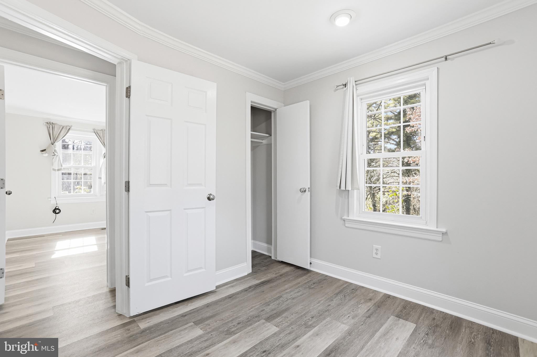 8324 Newland Road Warsaw, VA 22572 - Photo 20 of 31 an empty room with wooden floor and windows