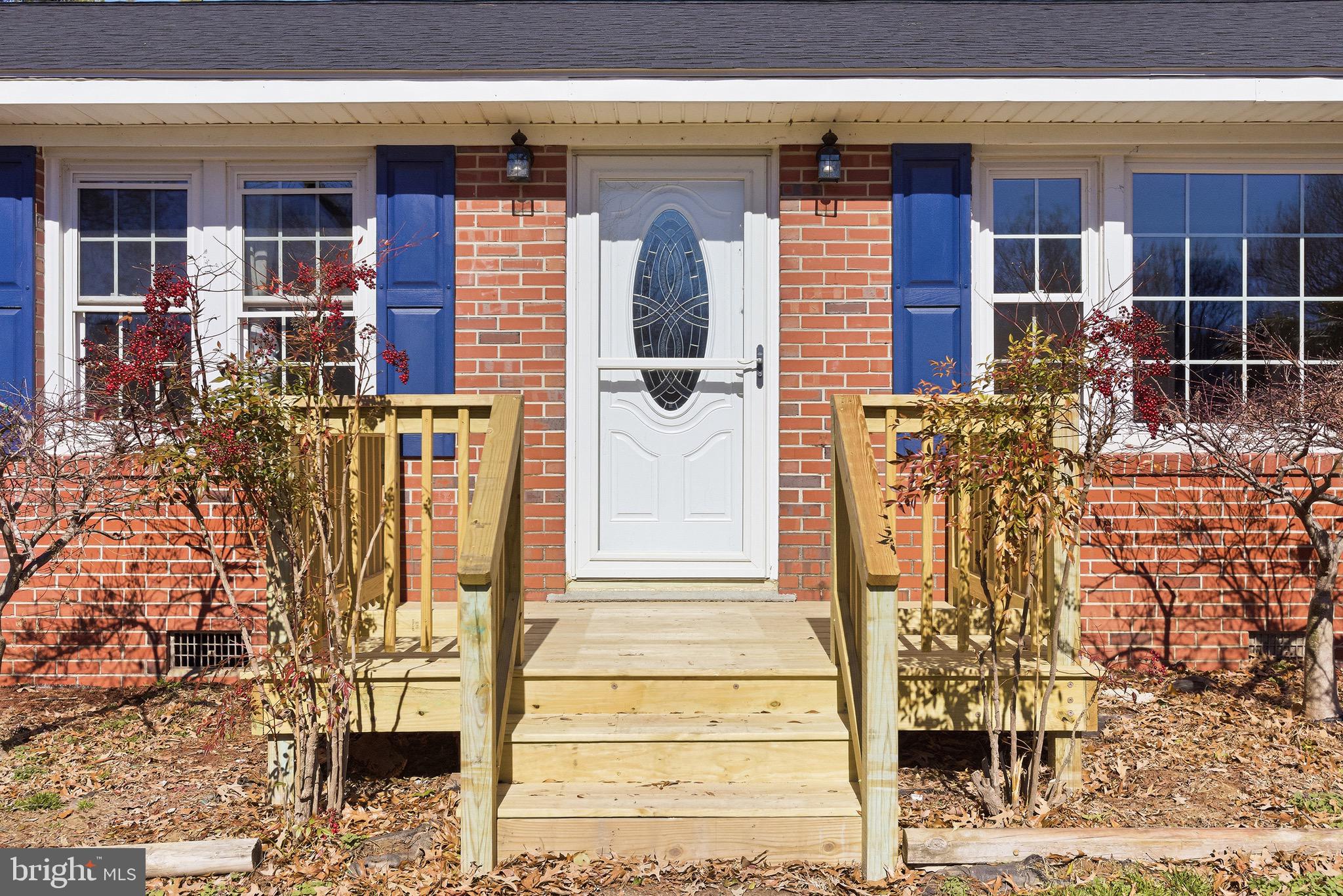 8324 Newland Road Warsaw, VA 22572 - Photo 2 of 31 a front view of a house with glass windows