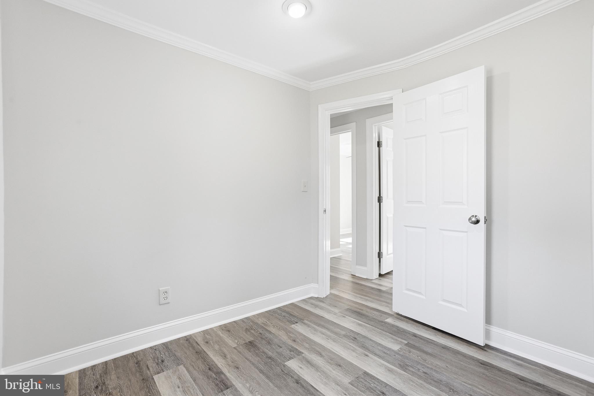 8324 Newland Road Warsaw, VA 22572 - Photo 21 of 31 an empty room with wooden floor and closet