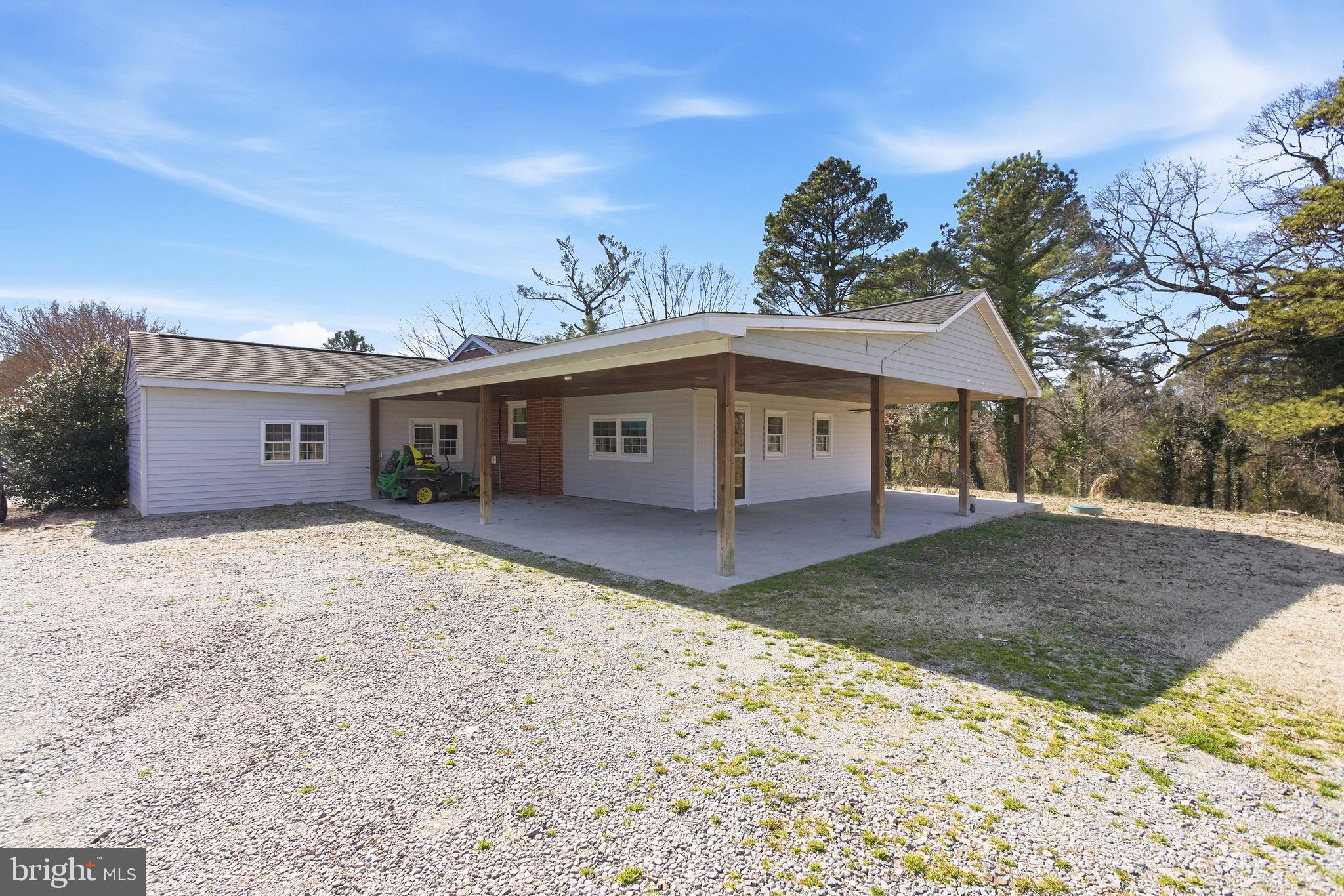 8324 Newland Road Warsaw, VA 22572 - Photo 29 of 31 a front view of a house with a yard and garage