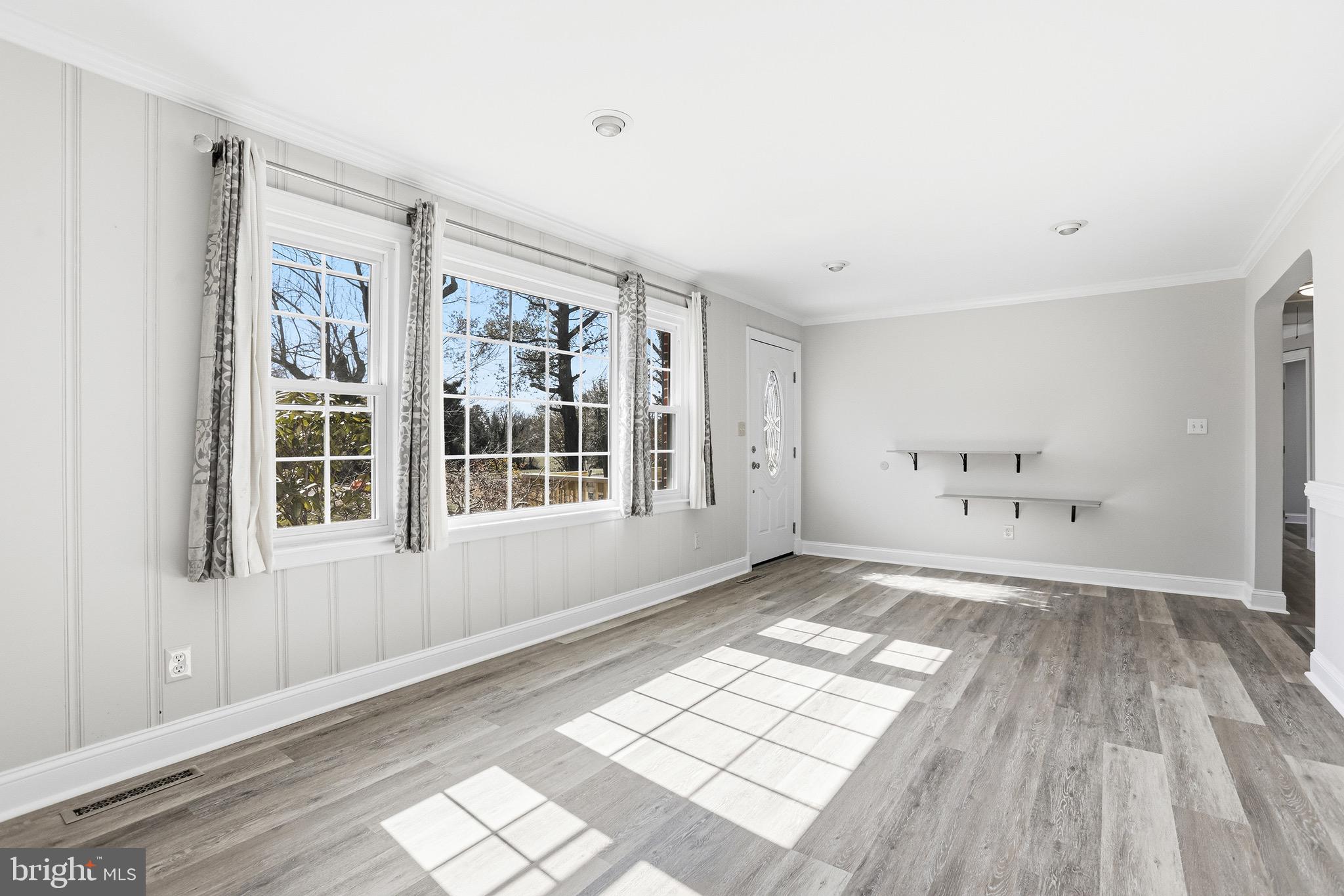 8324 Newland Road Warsaw, VA 22572 - Photo 5 of 31 a view of an empty room with wooden floor and a window