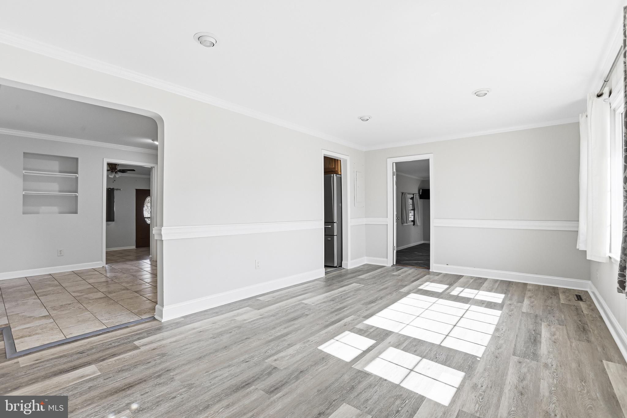 8324 Newland Road Warsaw, VA 22572 - Photo 6 of 31 wooden floor in an empty room with a window