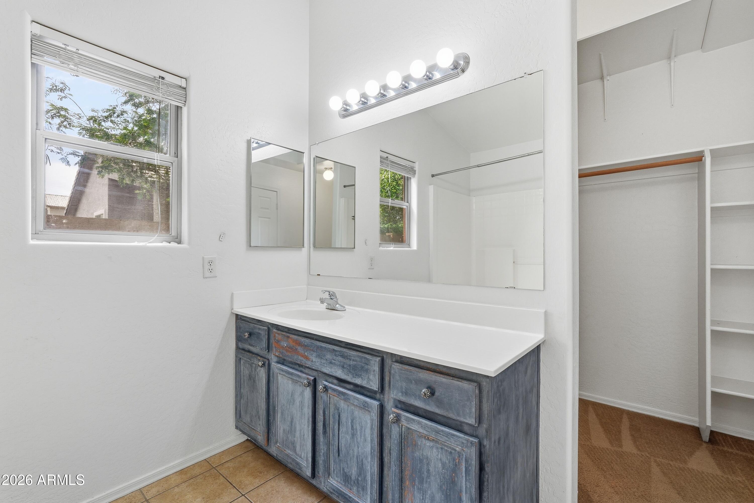 3242 East Bonanza Road Gilbert, AZ 85297 - Photo 24 of 36 a bathroom with a sink and a mirror
