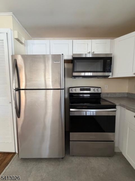 113 D North Shore Point Montague, NJ 07827 - Photo 5 of 18 a kitchen with stainless steel appliances a refrigerator a stove a microwave and cabinets