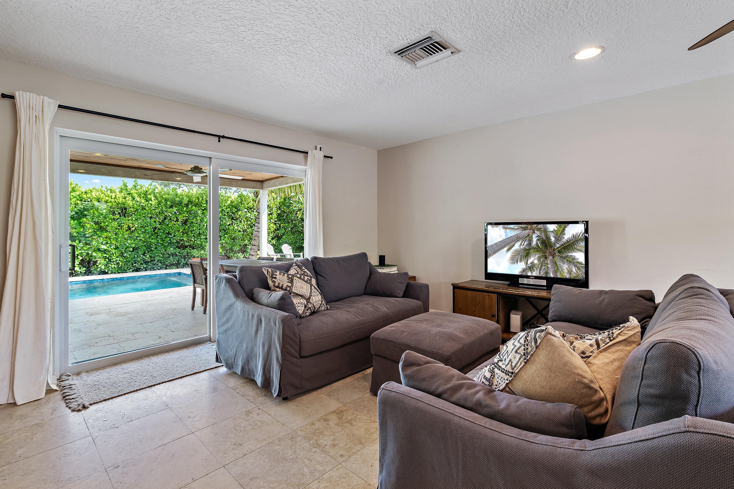 356 Mars Avenue Tequesta, FL 33469 - Photo 15 of 27 a living room with furniture and a flat screen tv