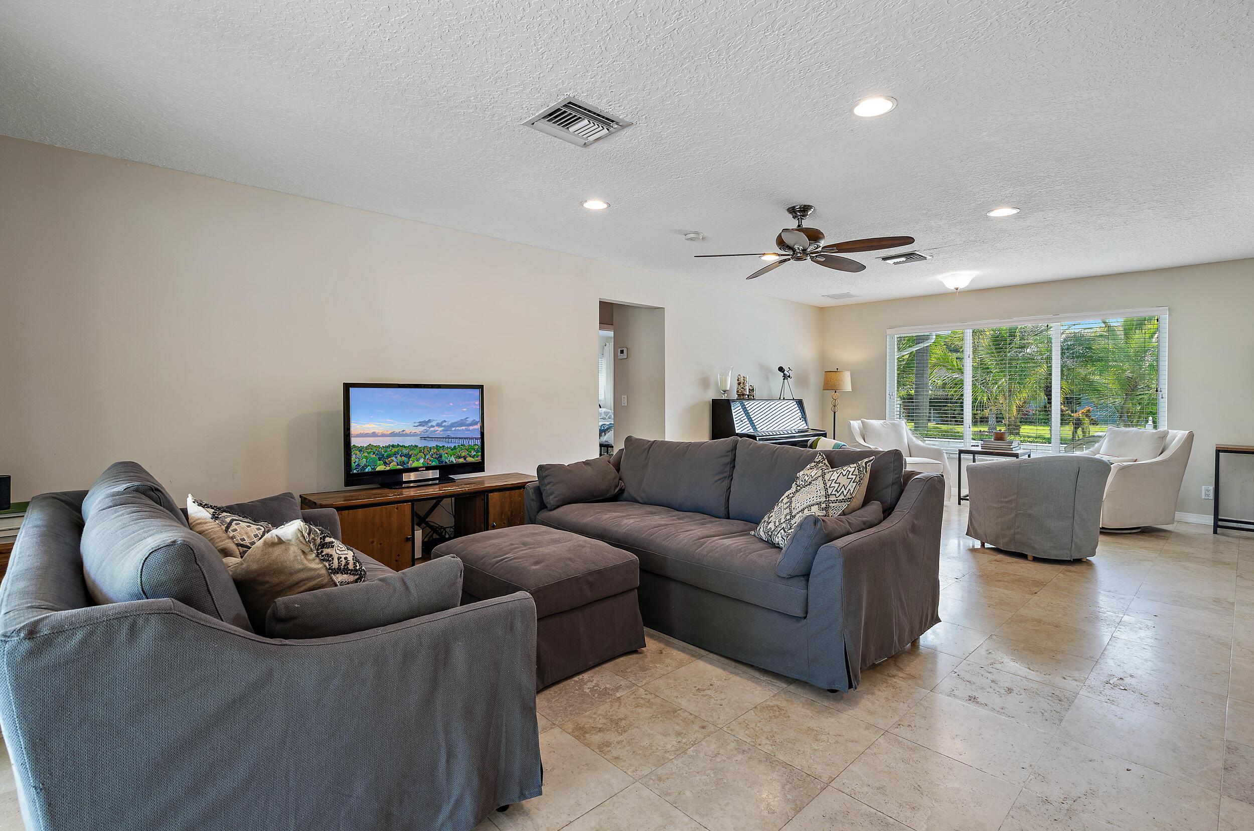 356 Mars Avenue Tequesta, FL 33469 - Photo 16 of 27 a living room with furniture and a flat screen tv