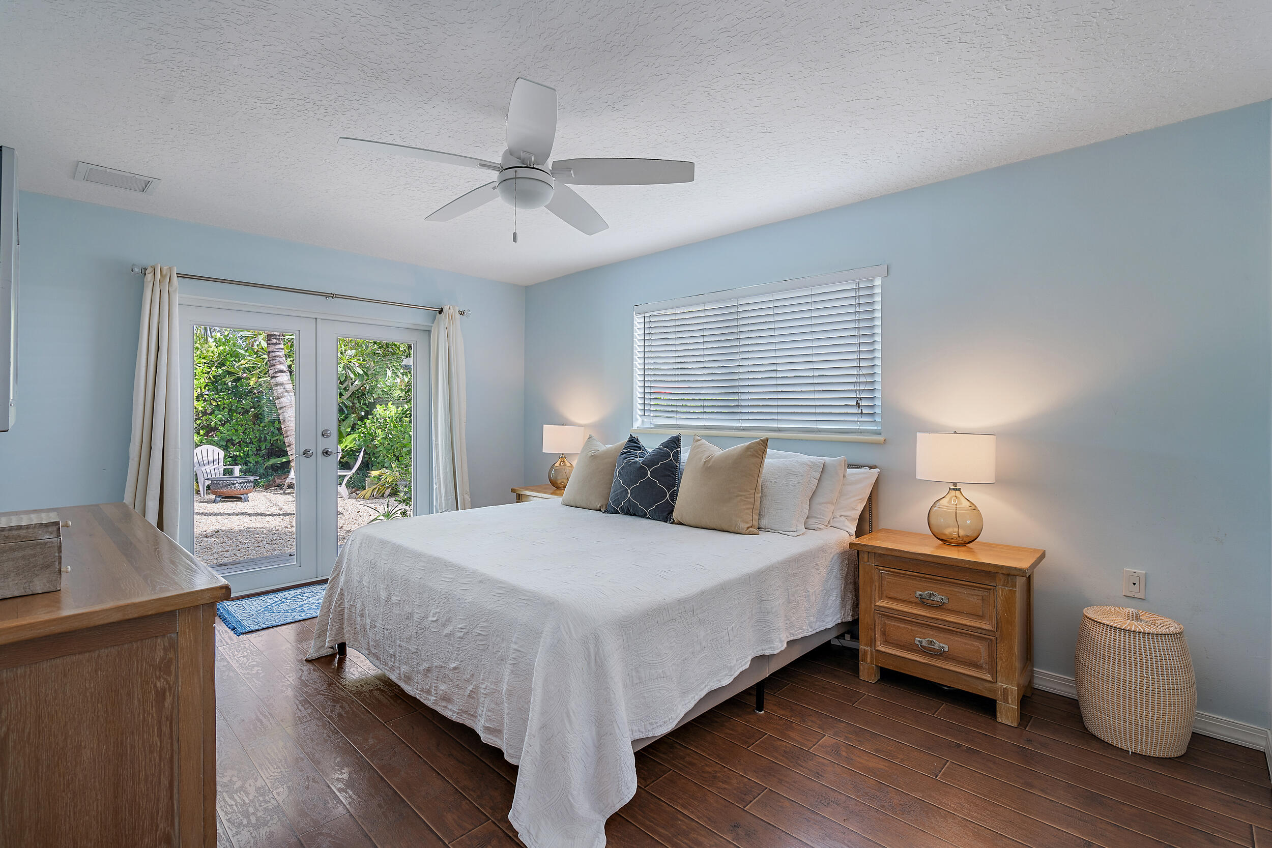 356 Mars Avenue Tequesta, FL 33469 - Photo 17 of 27 a bedroom with a bed and wooden floor