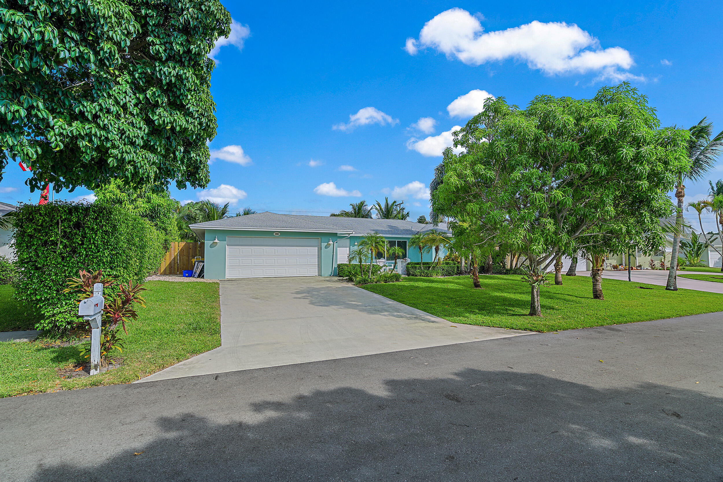 356 Mars Avenue Tequesta, FL 33469 - Photo 26 of 27 a view of a house with a backyard and a road