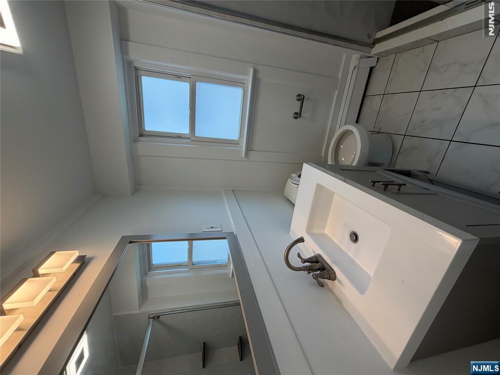 53 Devon Terrace, Unit 2 Kearny, NJ 07032 - Photo 7 of 15 a bathroom with a sink and a toilet