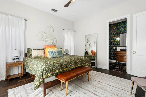 a bedroom with a bed and wooden floor