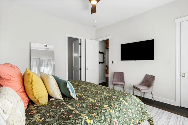 a bedroom with a bed and a flat screen tv