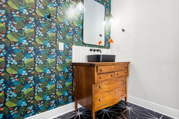 a bedroom with a bed tv and a chair
