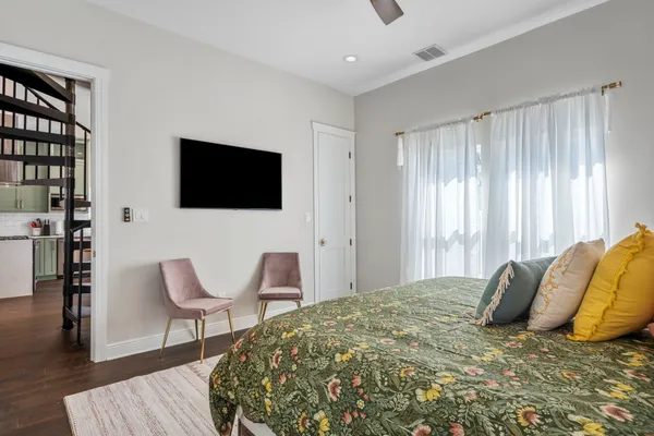 a bedroom with a large bed and a couch