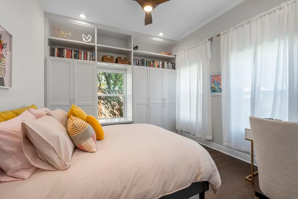 a bedroom with a bed and a table in it