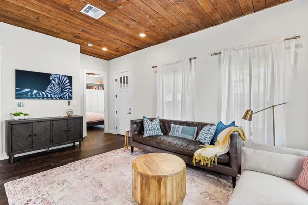 a living room with furniture a couch and a flat screen tv