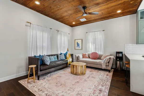 a living room with furniture and a wooden floor