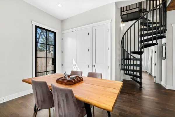 a view of a dining room with furniture and wooden floor