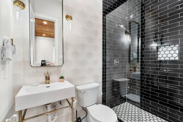 a bathroom with a sink toilet and shower