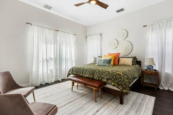 a bedroom with a bed and wooden floor