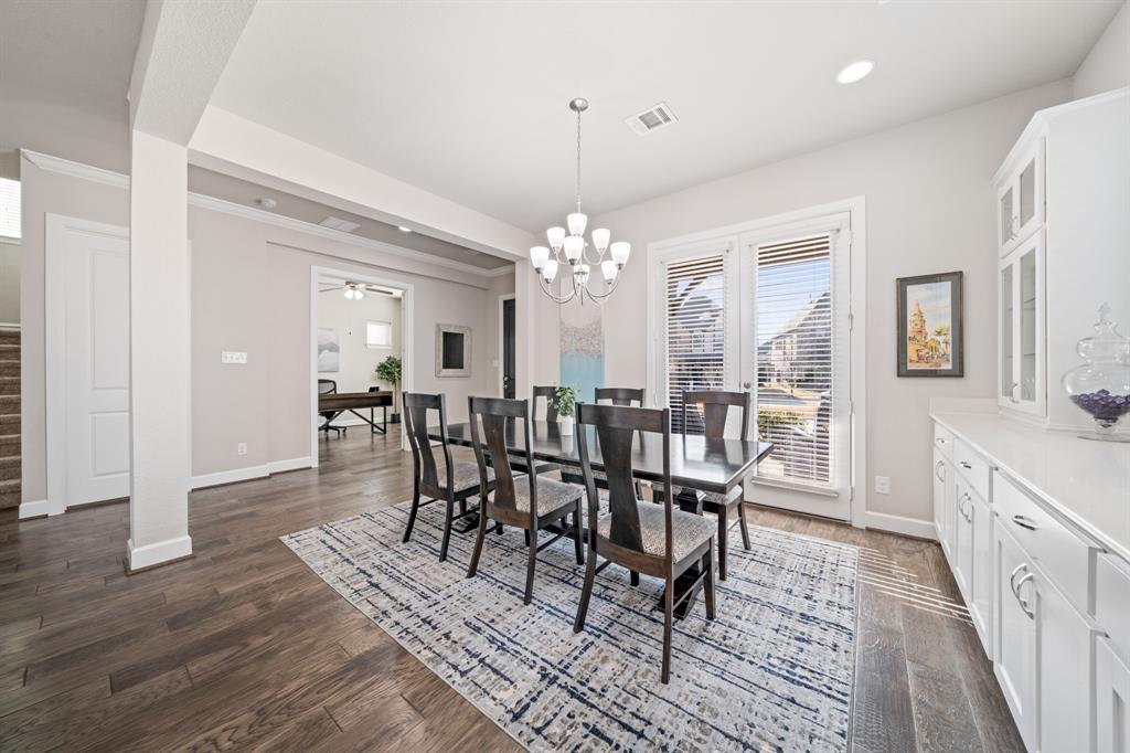 16548 Indiangrass Road Frisco, TX 75033 - Photo 7 of 39 a view of a dining room with furniture window and wooden floor