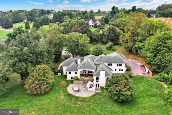 an aerial view of a house with garden space and street view
