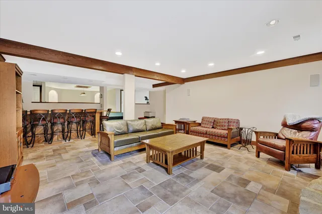 a living room with lots of furniture and a rug
