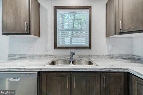 a kitchen with stainless steel appliances granite countertop a sink stove microwave and cabinets