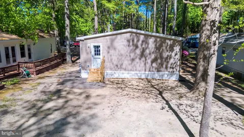a view of a house with backyard and wooden floor