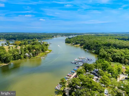 a view of a lake with boats house swimming pool and outdoor space