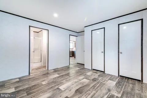 a kitchen with stainless steel appliances granite countertop a refrigerator a oven a sink dishwasher and a refrigerator with wooden floor