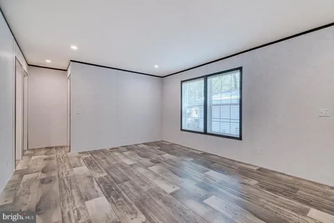 a view of a livingroom with an empty space and a window